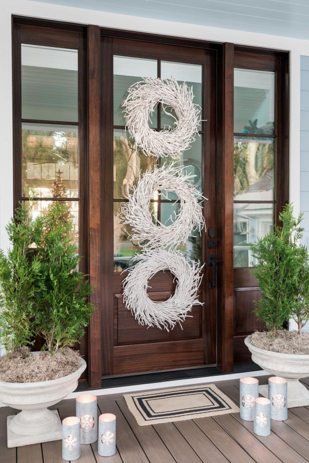 outdoors-inspired decorated holiday porch with rake and window frame